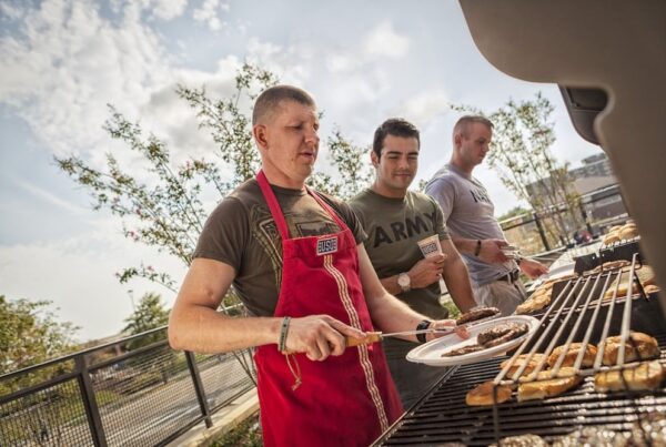 Three men grilling outdoors