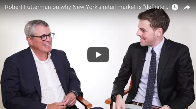 Two men smiling in an interview setup about New York's retail market.