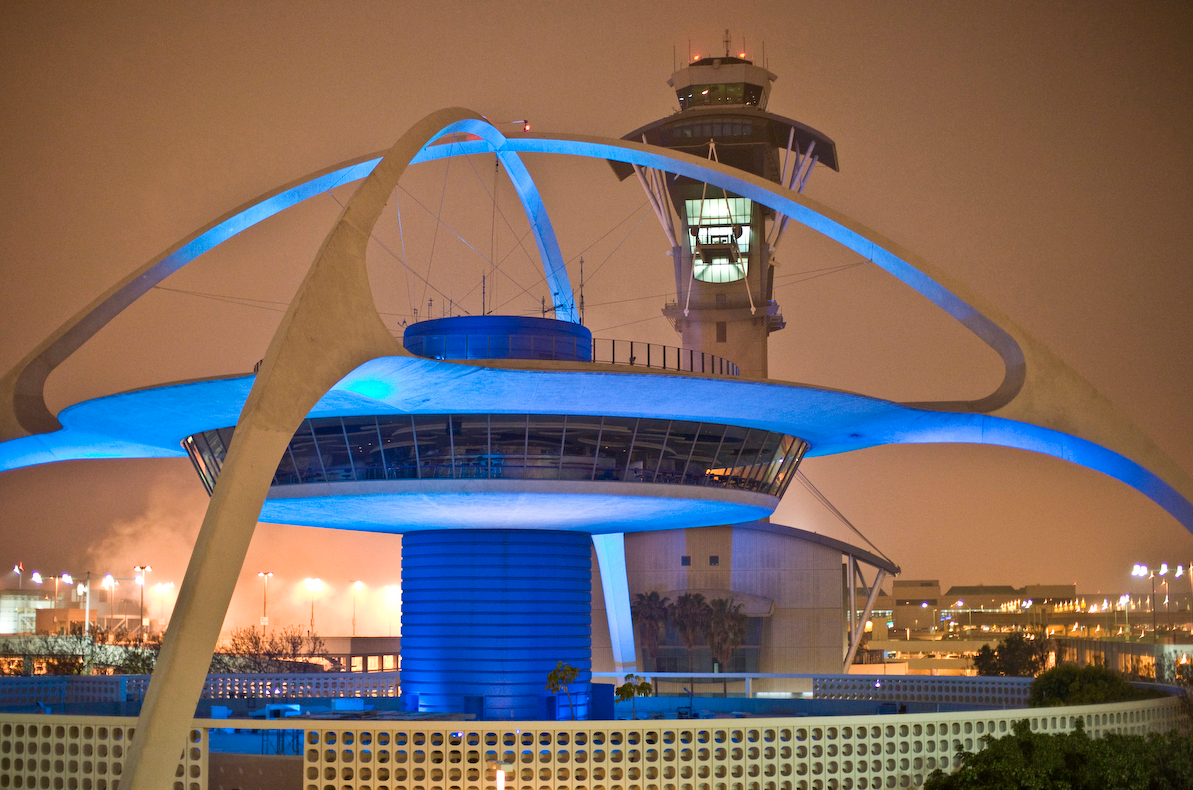Iconic airport tower with futuristic blue lighting at night