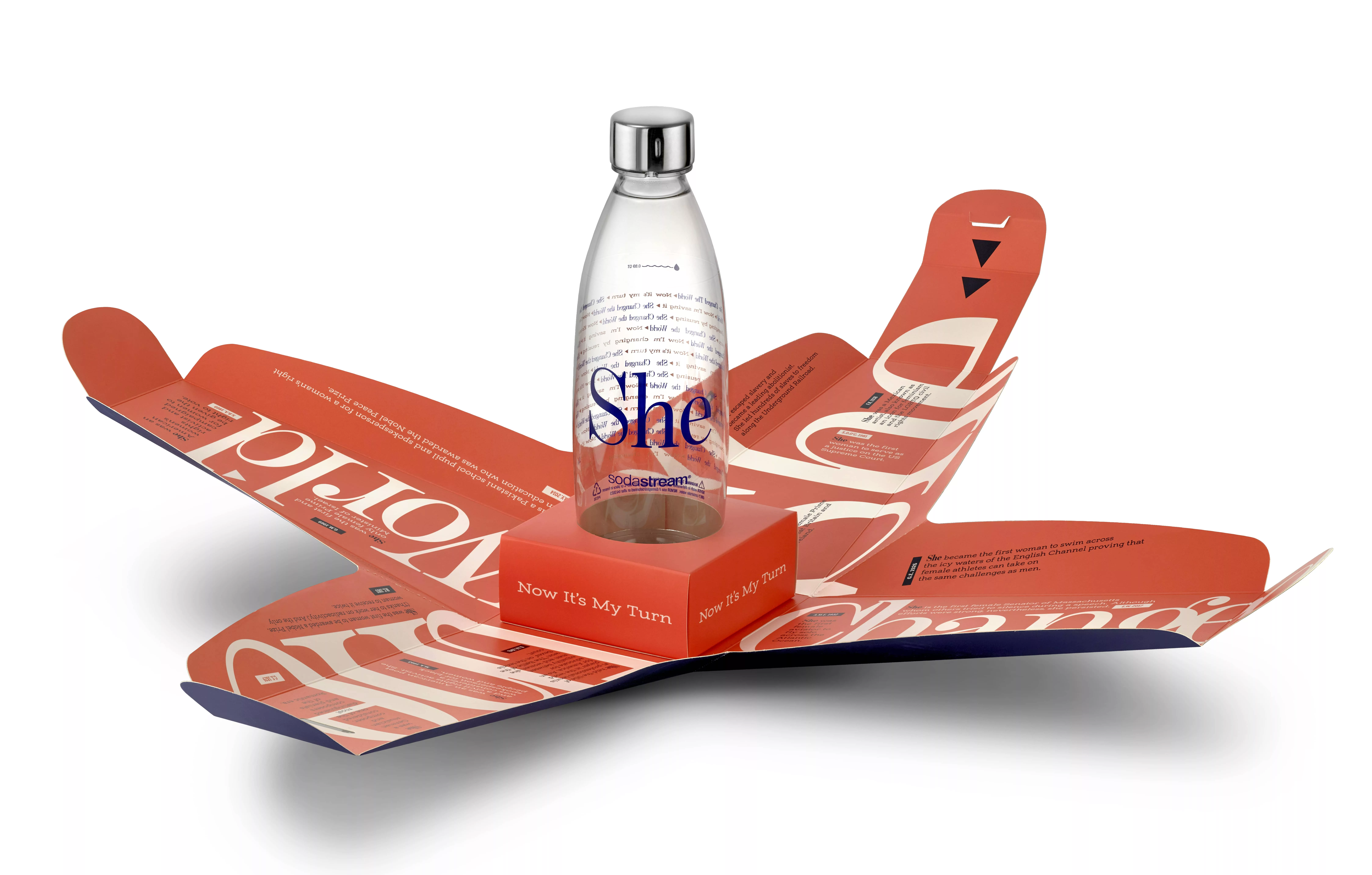 Reusable water bottle with empowering "She" design on opened cardboard packaging