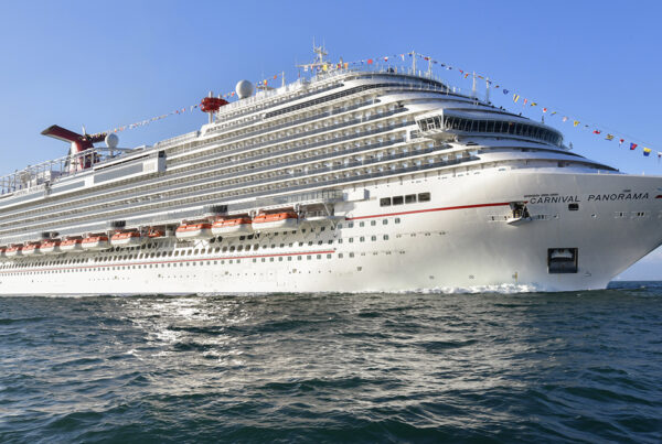 Carnival Panorama cruise ship sailing on the ocean with clear skies