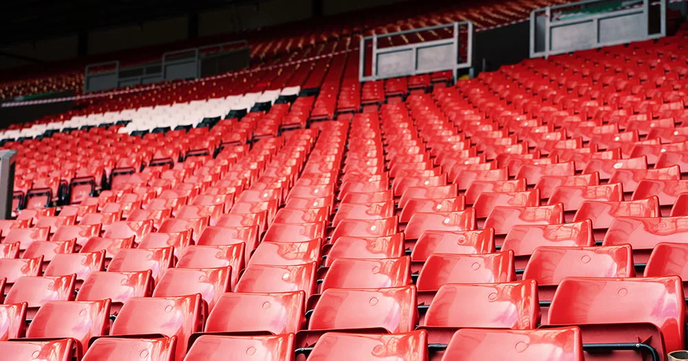 Empty red stadium seats with selective focus and blurred background