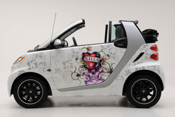 Custom-wrapped compact car with graffiti-style graphics and skull artwork