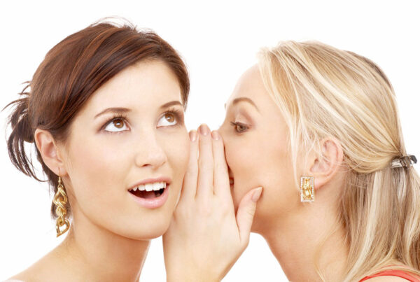 Two women sharing a secret