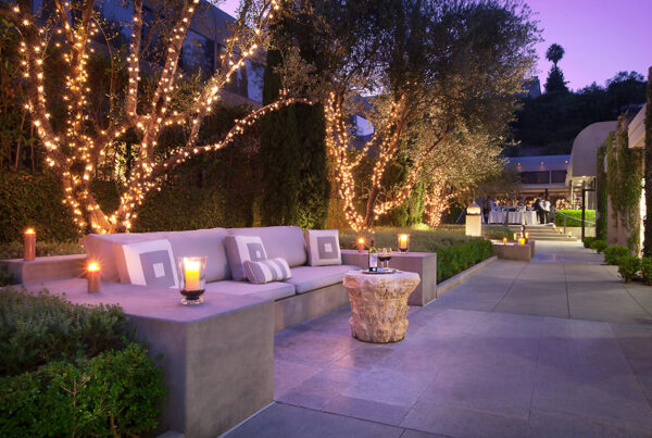 Outdoor evening event space with fairy lights and modern seating area