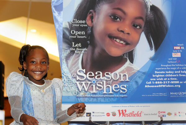 Smiling girl in princess costume at Season of Wishes charity event poster
