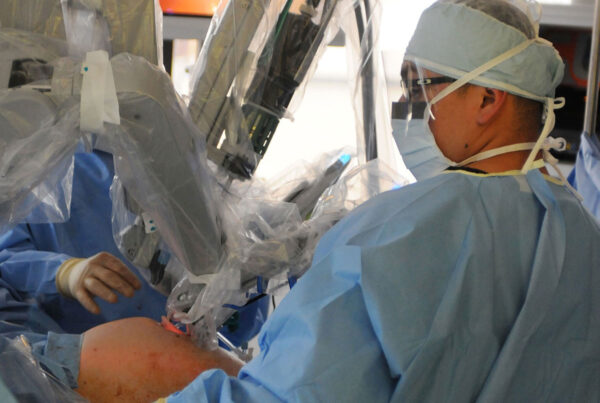 Surgeon performing robotic-assisted surgery in operating room