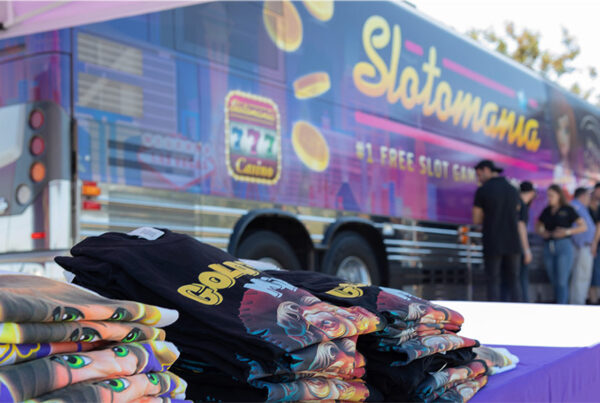 Promotional event with Slotomania branded bus and merchandise t-shirts.