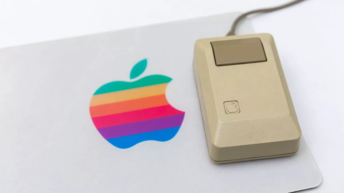 Vintage Apple mouse on pad with classic rainbow logo