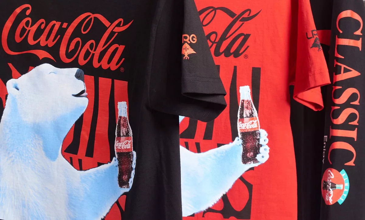 Coca-Cola branded T-shirts with logo and polar bear design.