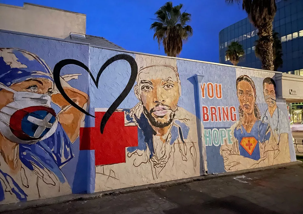 Mural of healthcare workers with heart symbol and "You Bring Hope" message