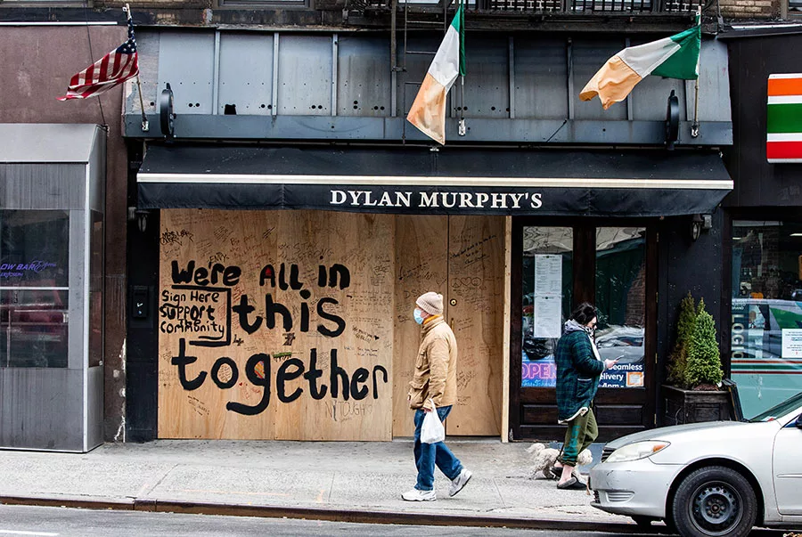 Boarded-up store with supportive community message