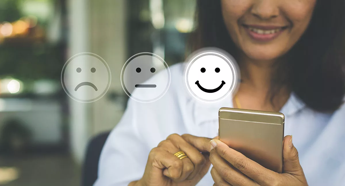 Woman using smartphone with floating customer service satisfaction icons