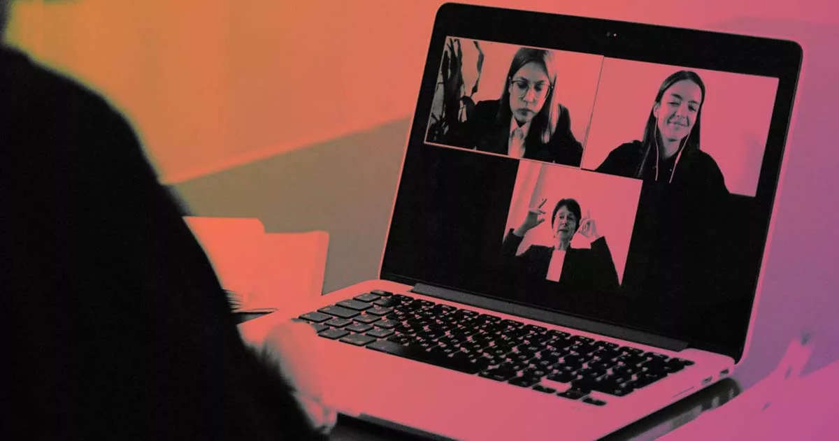 Person on a video call with three participants on their laptop screen.