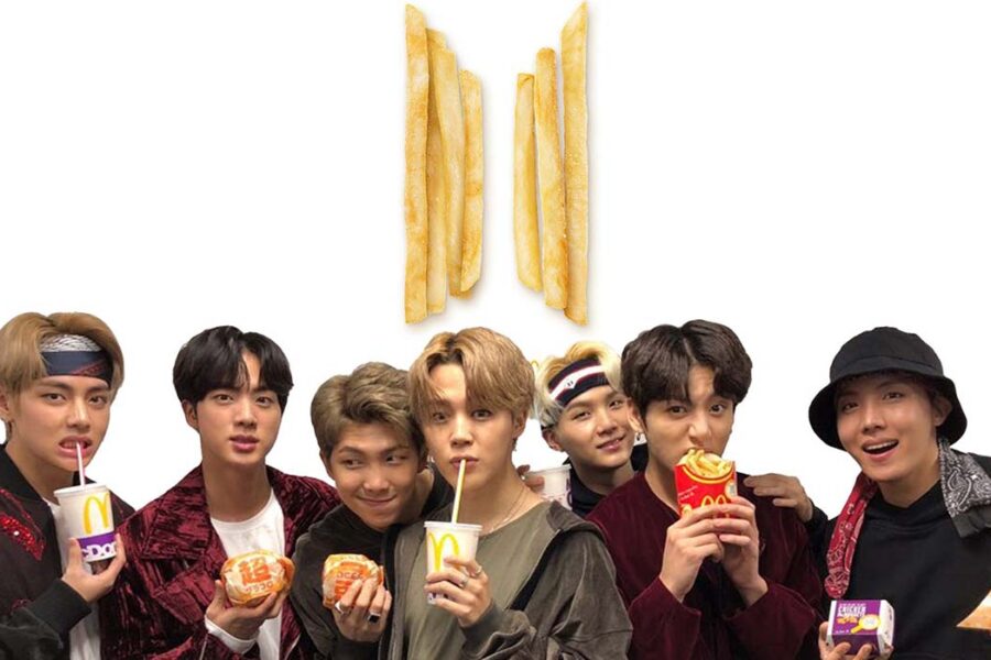 Seven people holding McDonald's food items