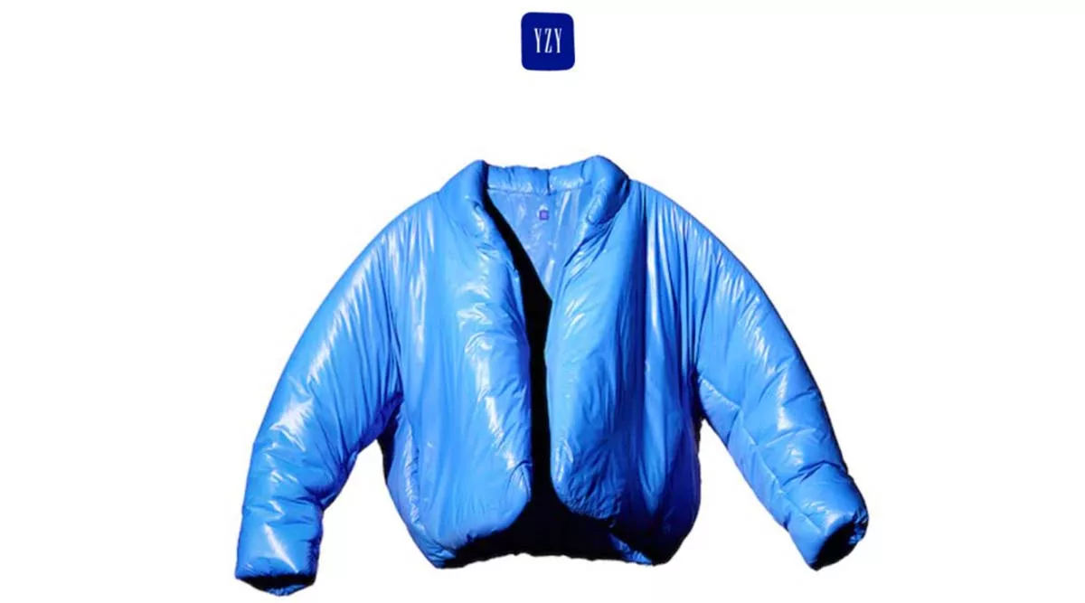 Blue puffer jacket with YZY logo on white background.