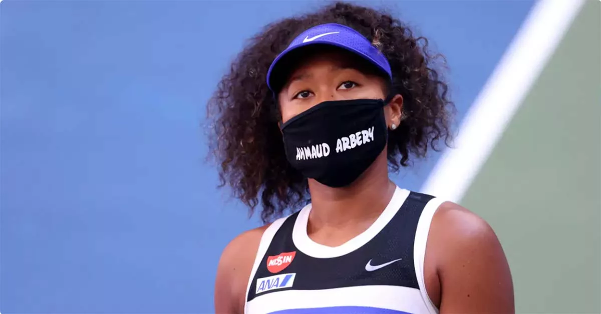Athlete wearing mask with 'Ahmaud Arbery' text and Nike sponsorship.