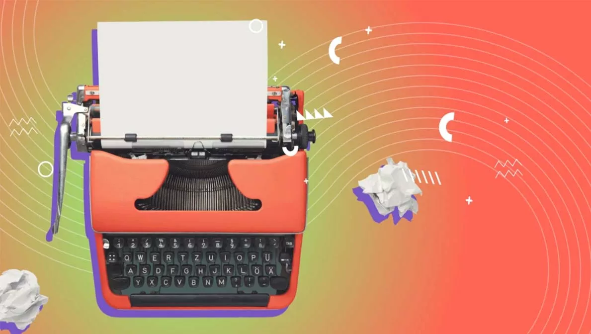 Vintage red typewriter with blank paper on a colorful abstract background.