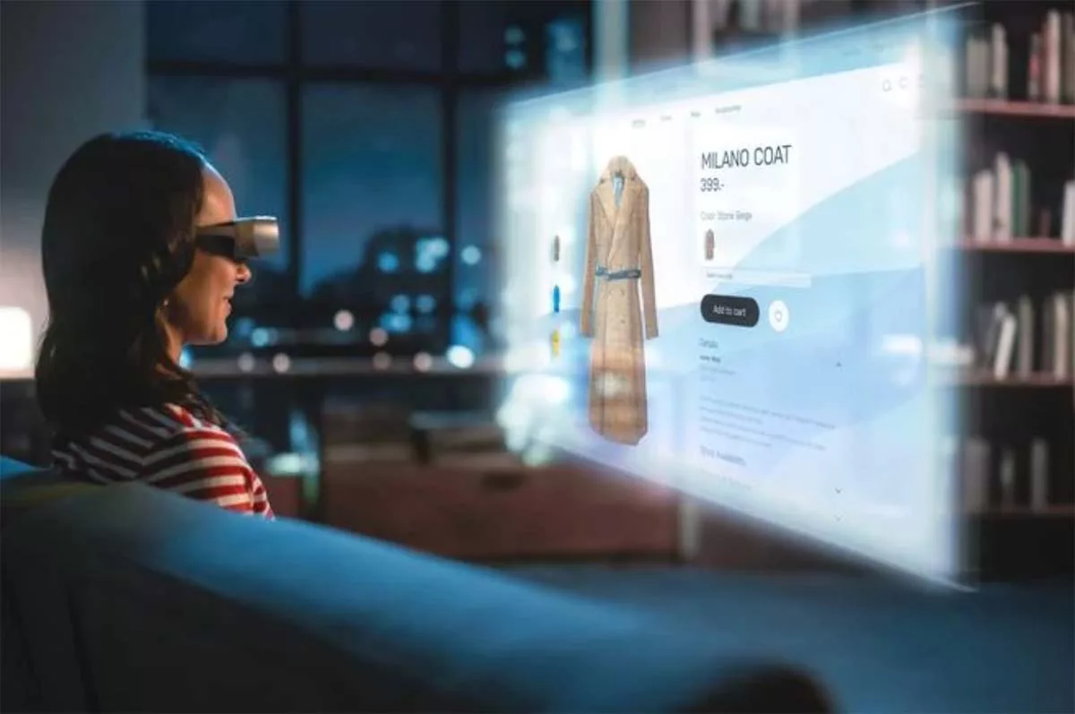 Woman using VR headset to shop for a Milano coat online at night