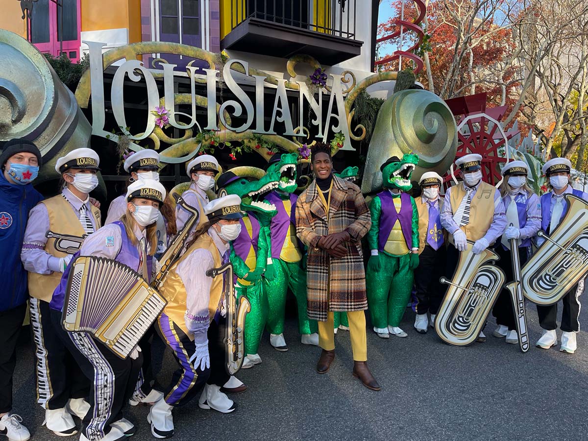 People in festive costumes with musical instruments at Louisiana-themed event