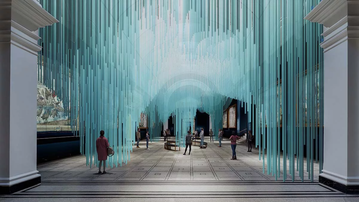 Art installation with hanging blue rods creating a tunnel effect in a gallery with visitors.