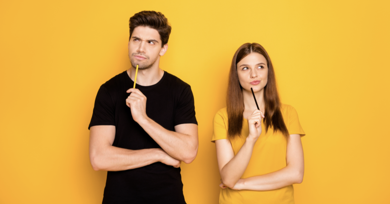Two people pondering with pens against a yellow background