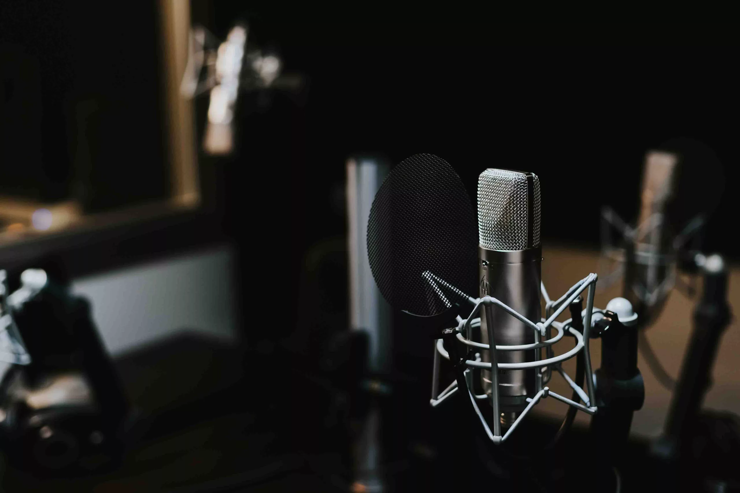 Professional studio microphone on dark blurred background
