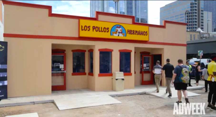 Los Pollos Hermanos restaurant facade with people walking by