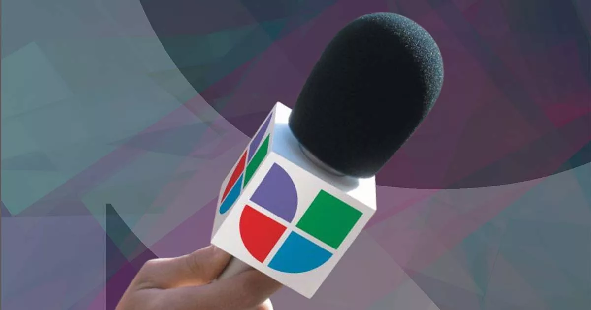 Hand holding microphone with colorful geometric logo against abstract background
