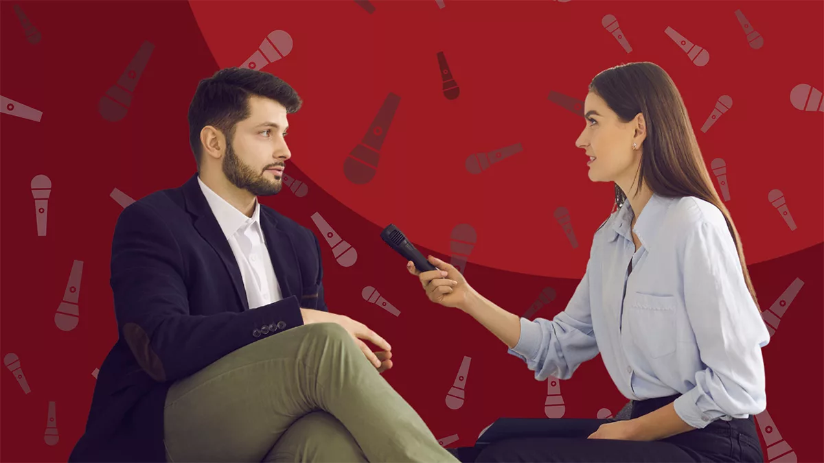 Woman interviewing a man against a red background with microphone icons.