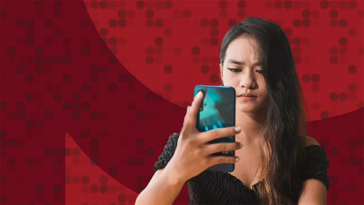 Woman checking smartphone with red abstract background