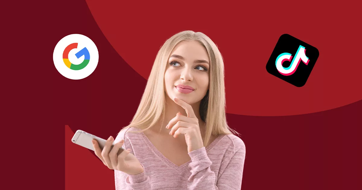 Woman comparing Google and TikTok logos on her smartphone