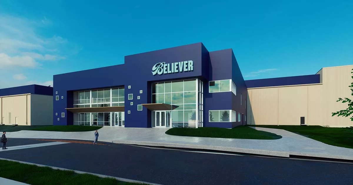 Modern blue corporate building with large windows and Believer logo