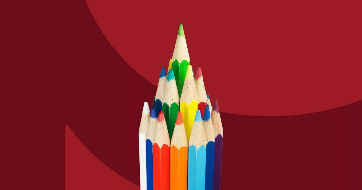 Colorful array of sharpened pencils on a red background