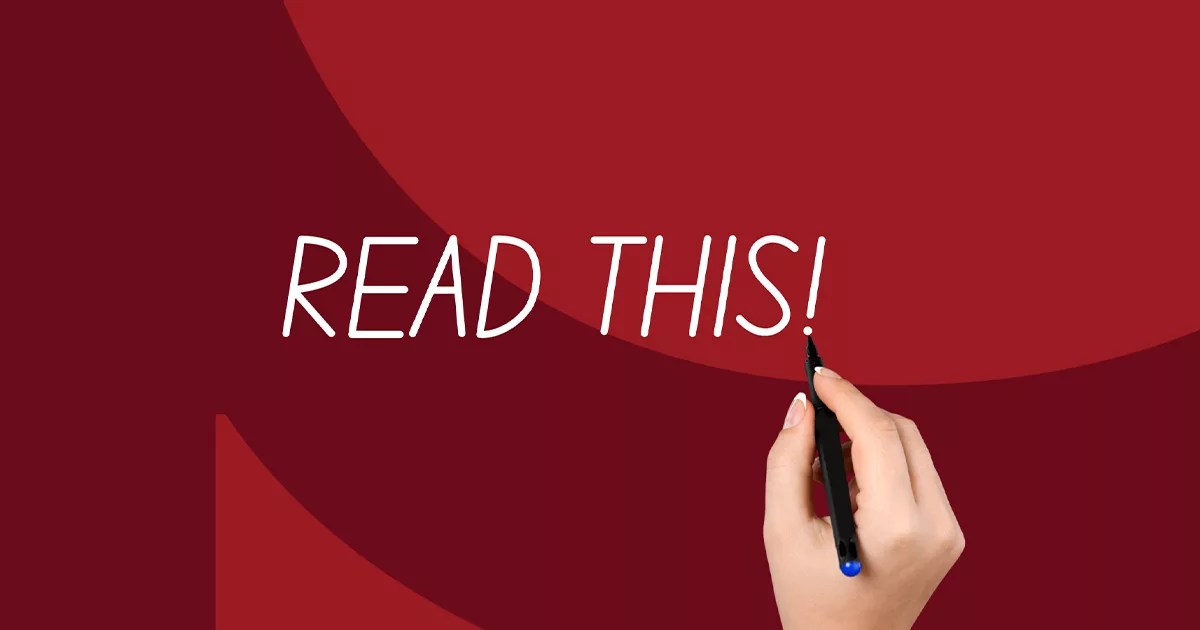 Hand writing "READ THIS!" on a red background with a marker