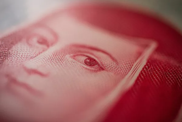 Close-up of a red banknote with detailed eye engraving
