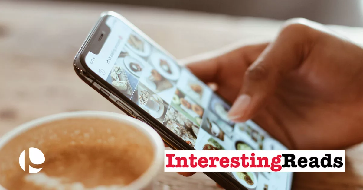 Person browsing on smartphone with social media images next to coffee cup.