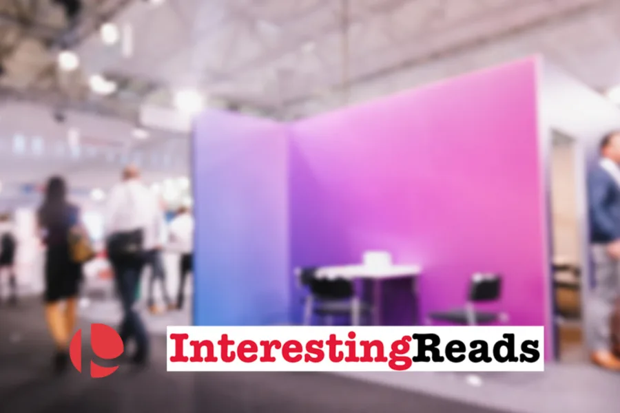 Conference booth with a purple gradient wall