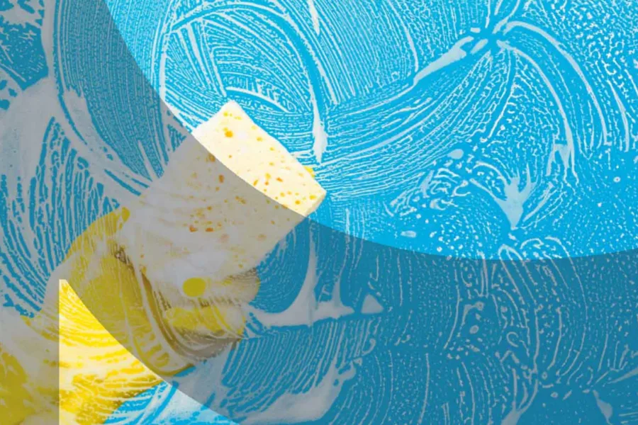 Yellow sponge cleaning soapy blue glass surface