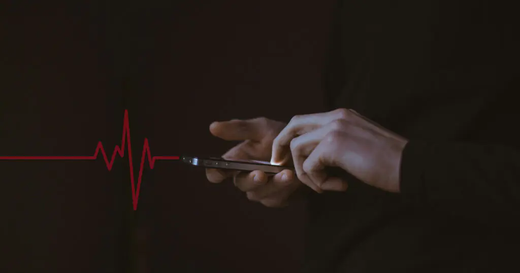 Hands using smartphone with heartbeat line overlay