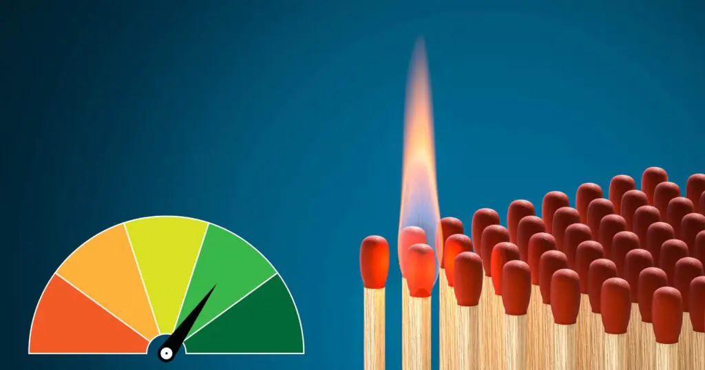 Lit matchstick among unlit ones with a nearby risk gauge