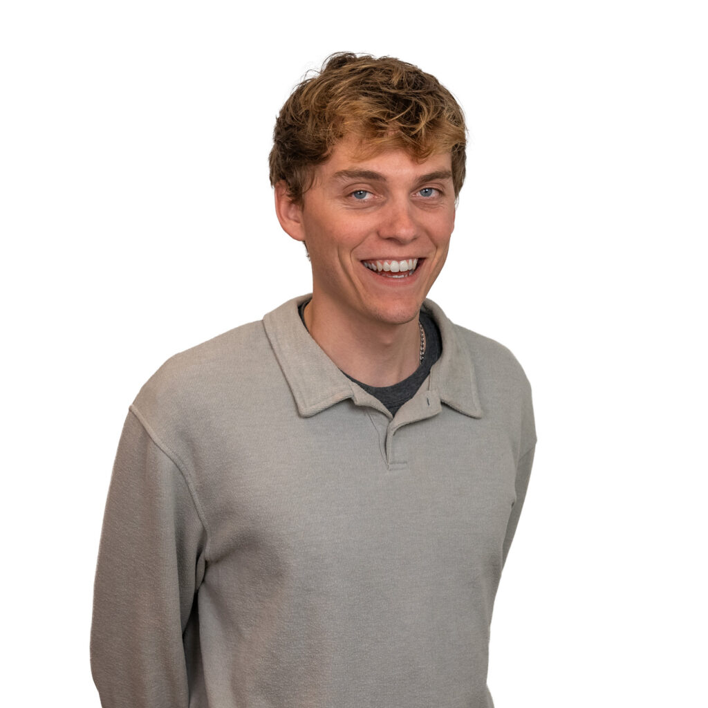 jackson-headshot Smiling young man in grey sweater