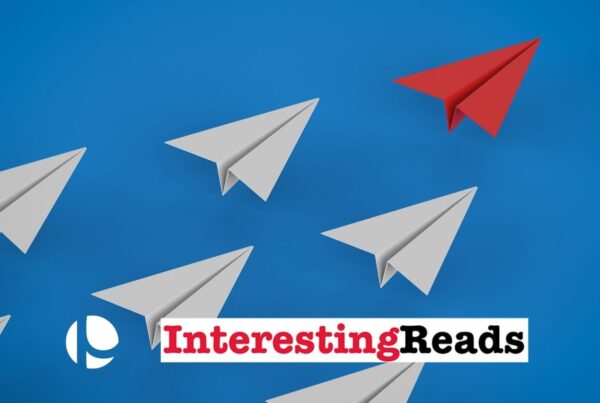 Red paper airplane leading a pack of white paper airplanes on a blue background