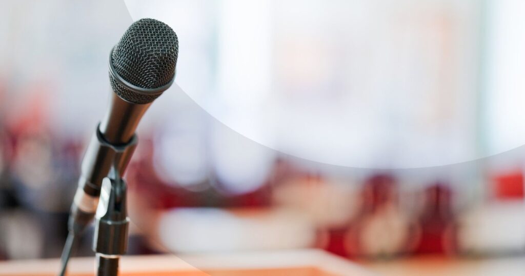 Microphone stand in front of a crowd