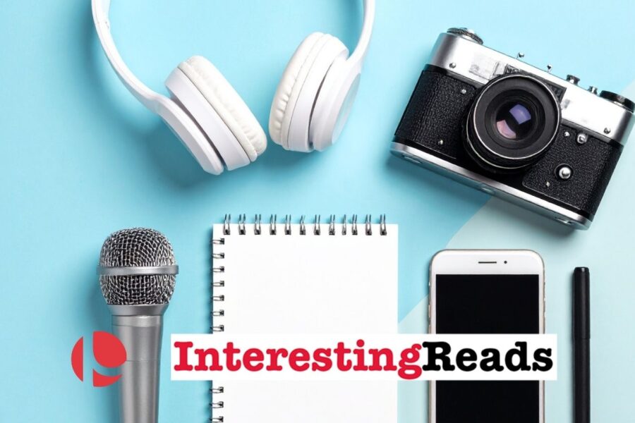 Headphones, a camera, a microphone, a notepad, a cell phone, and a pen laying against a light blue and white background.