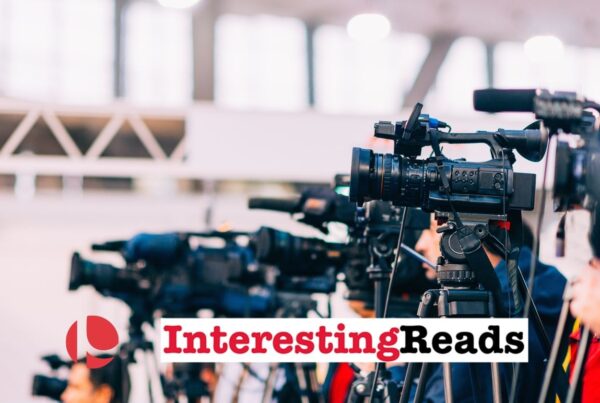 A line of cameras pointing to the left against a white background.