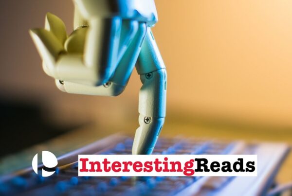 A robotic hand coming down from the top of the screen, extending its index finger and pressing a key on a computer keyboard.