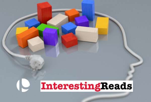 An electric chord paid in the shape of a head with colored blocks resting in what would be the area of the brain against a gray background.
