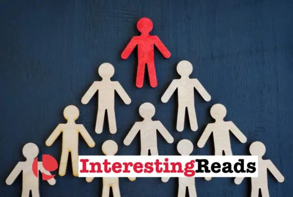 A blue background with a triangle of white stick figures and a red stick figure at the top.